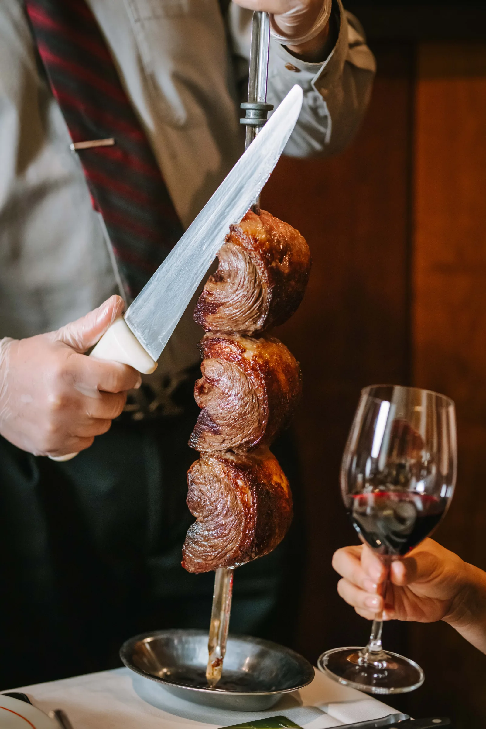 Gaucho carving meat tableside at VB Steakhouse